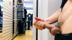 Risky jerking off in a shop's fitting stall