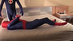 Sexy guy dressed as Spider-man gets down with another man in bed