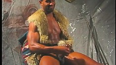 Fur clad black strongman rubs his shaft to a happy explosion